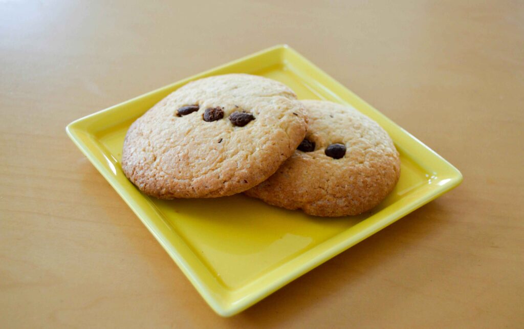 Two butter cookies on a yellow tray