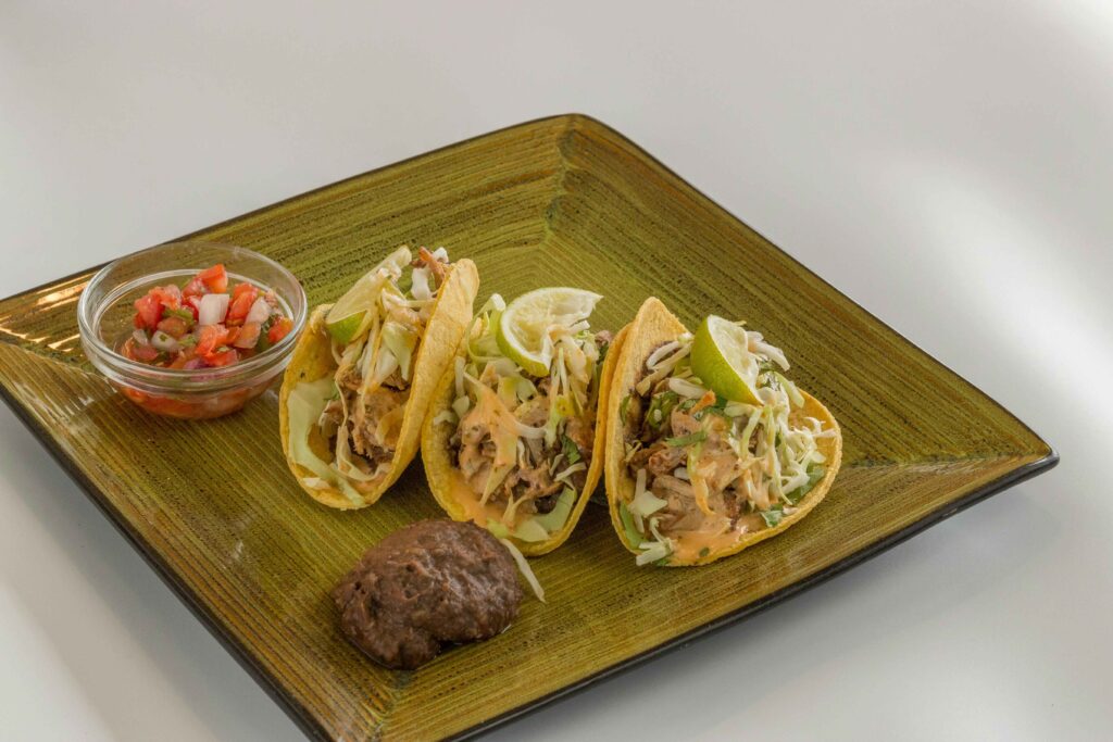 Grilled Fish Tacos Recipe served on a green plate.