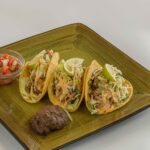 Grilled Fish Tacos Recipe served on a green plate.