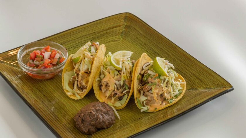 Grilled Fish Tacos Recipe served on a green plate.