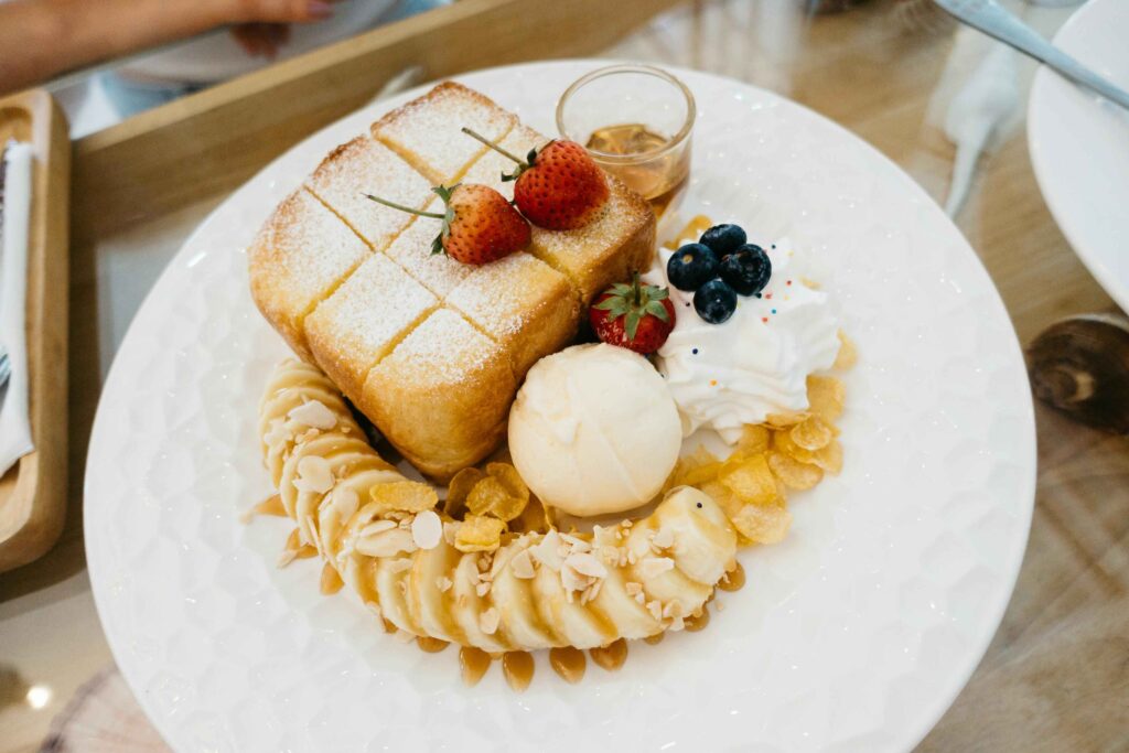 Toast and Chopped Banana kept on white plate.