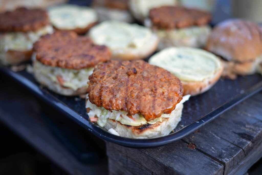 Grilled Black Been burgers placed on salver on wooden table.