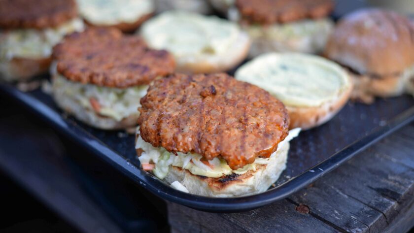 Grilled Black Been burgers placed on salver on wooden table.