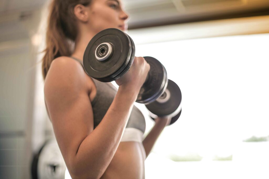 Girl lifting Dumbbell.