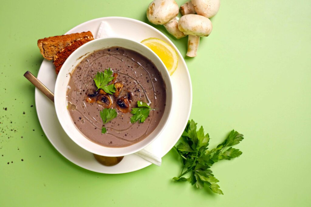 The soup is served in a white bowl placed on a white tray.