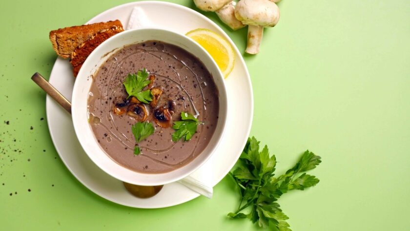 The soup is served in a white bowl placed on a white tray.