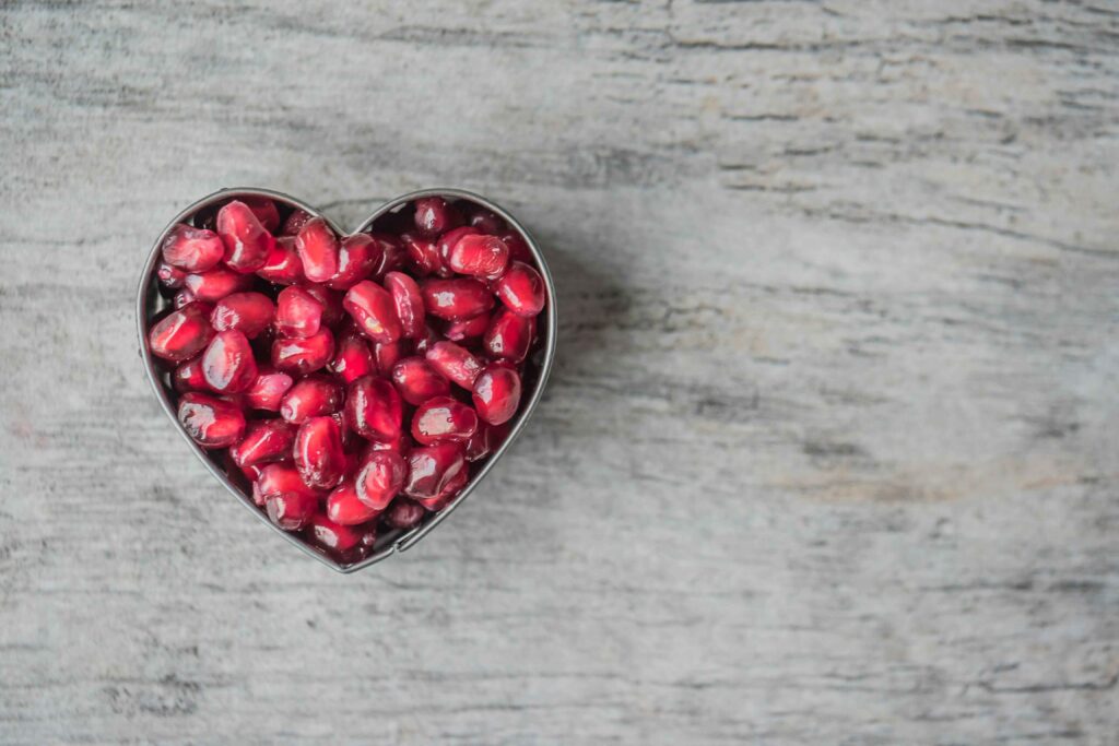 Silver Heart Bowl Filled of Red Pomegranate Seeds