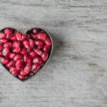 Silver Heart Bowl Filled of Red Pomegranate Seeds