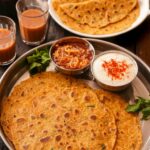 chilla served on plate with curd and tea