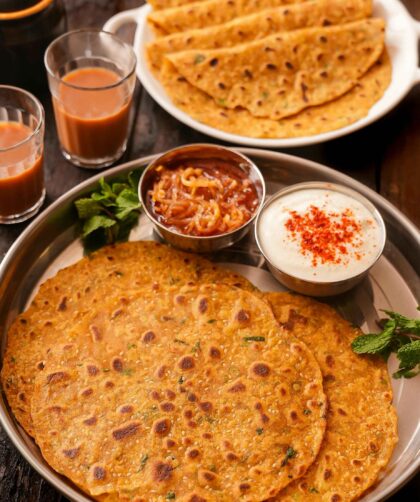 chilla served on plate with curd and tea