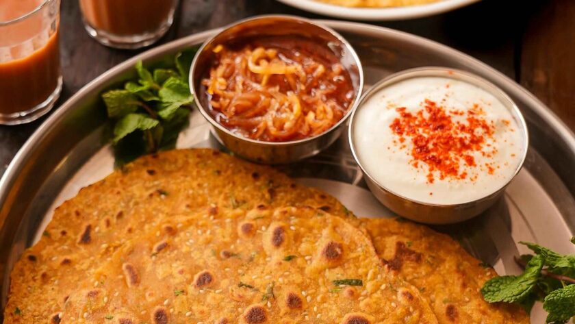 chilla served on plate with curd and tea