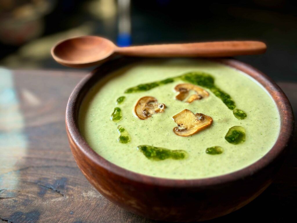 Green Mushroom Soup in a wooden Bowl