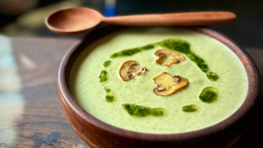 Green Mushroom Soup in a wooden Bowl