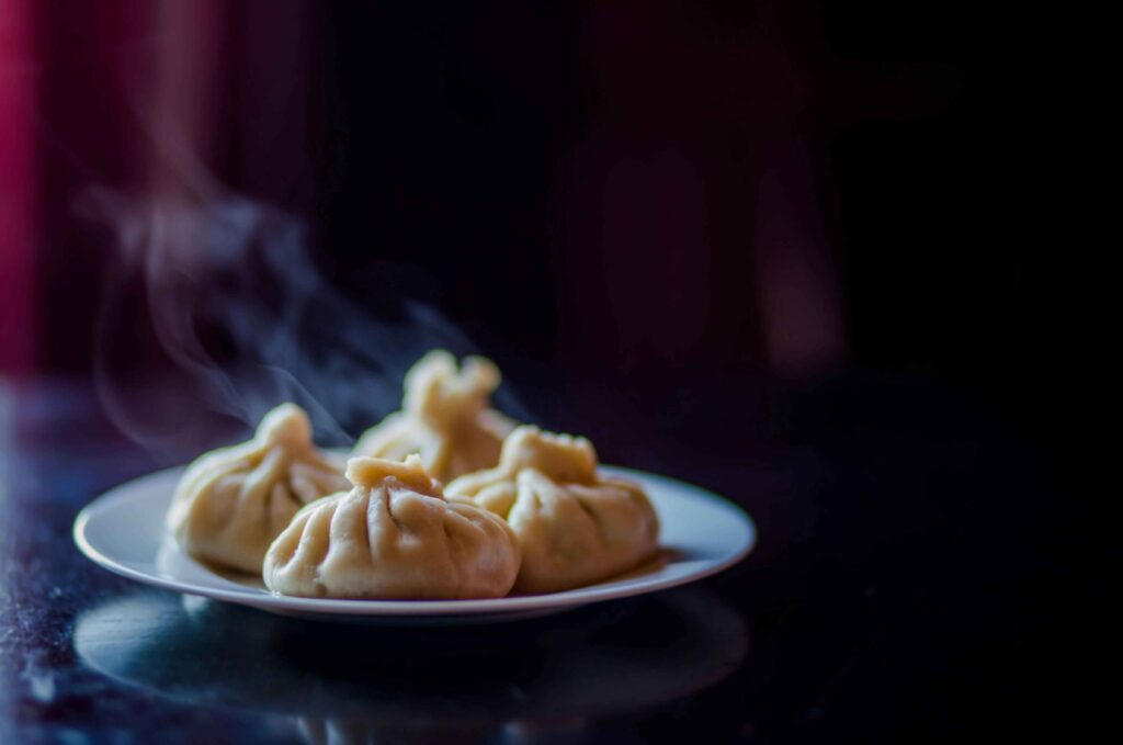 Chicken momos Served in a black plate