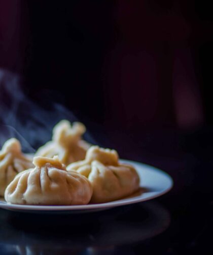 Chicken momos Served in a black plate