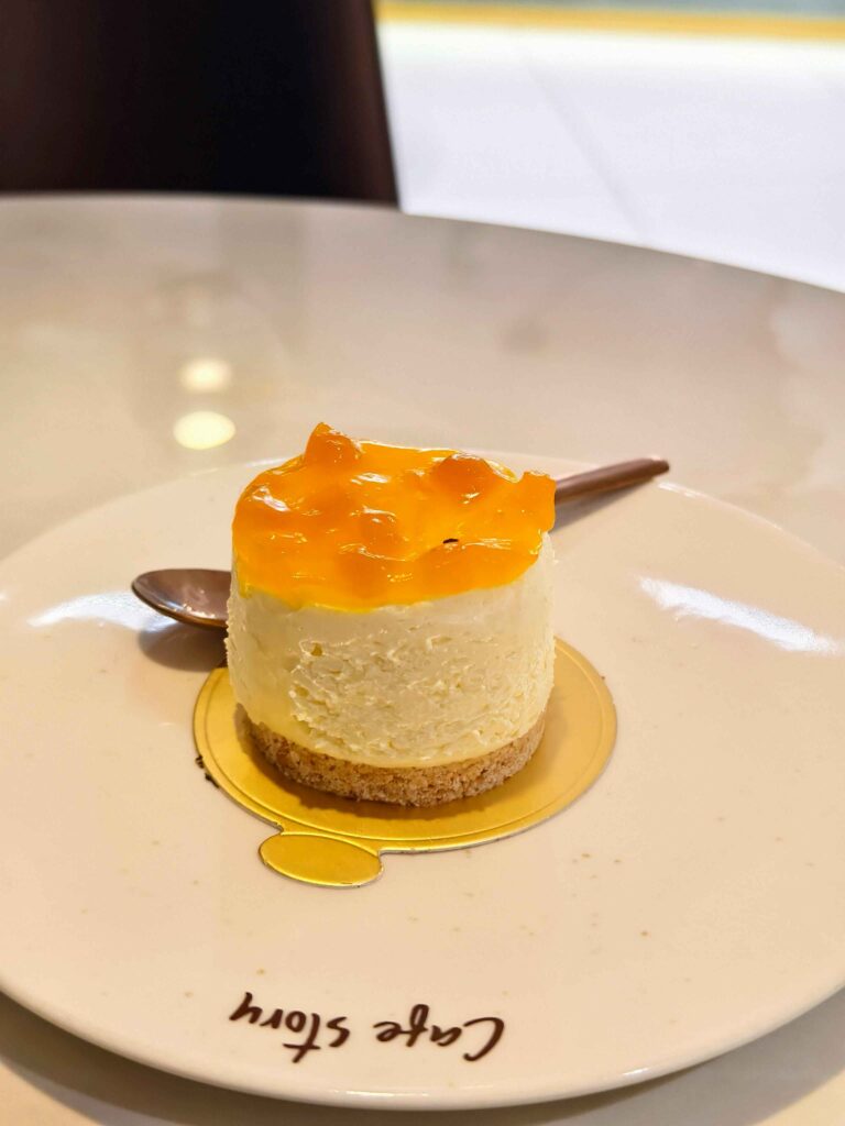 Best Mango Cheesecake served on a plate with a spoon