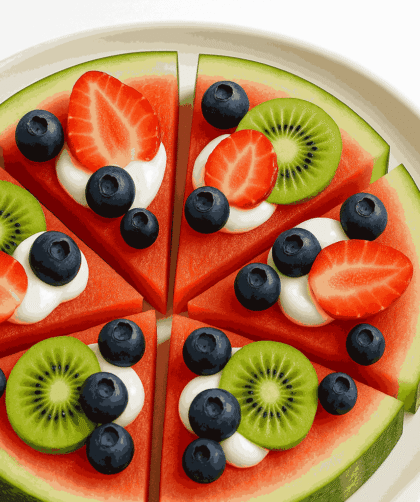 Watermelon fruit pizza served on a white plate