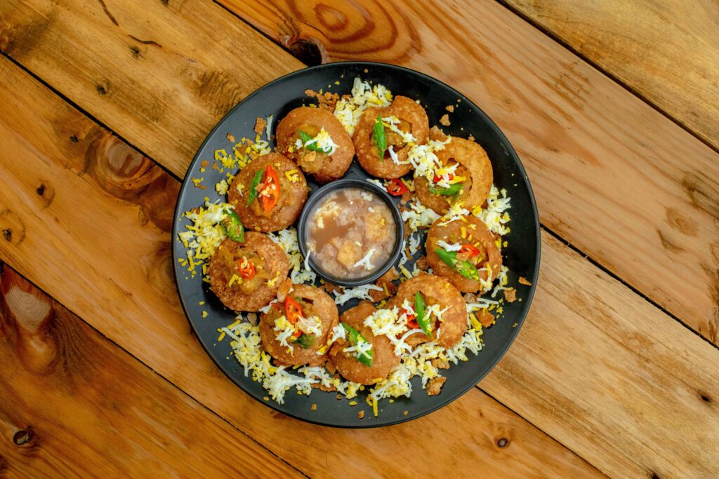 Dahi Puri served on a black plate