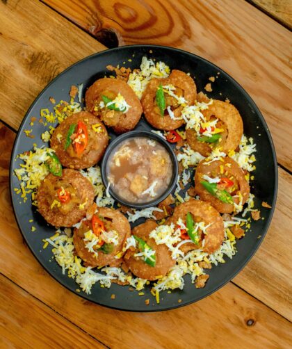 Dahi Puri served on a black plate