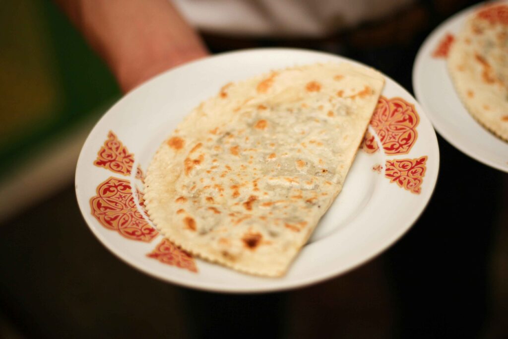 Onion Paratha served on a white plate