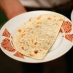 Onion Paratha served on a white plate