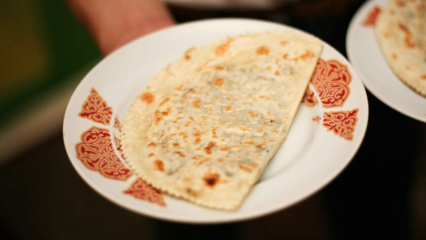 Onion Paratha served on a white plate