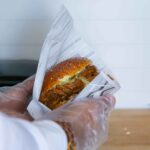 A person is holding Pork Burger